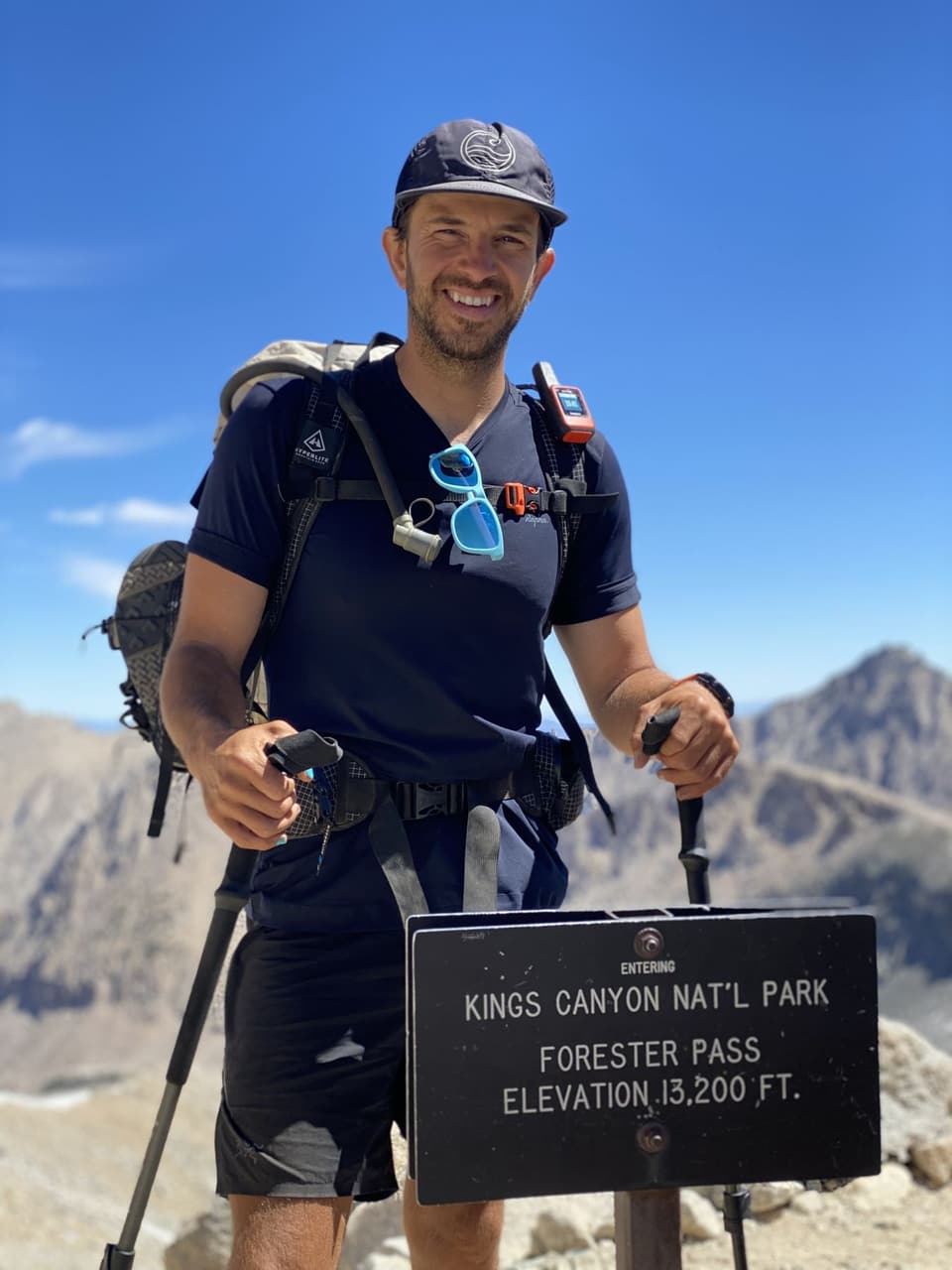 Atlas grinning at the Forester Pass sign