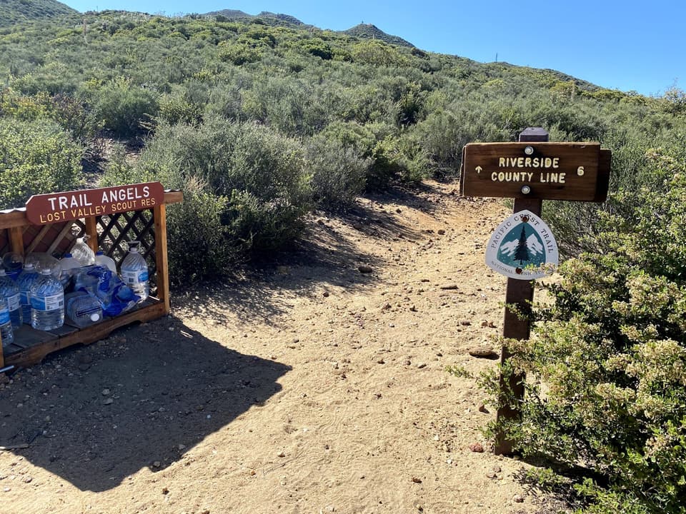 trail angel water cache beside the Riverside County Line sign