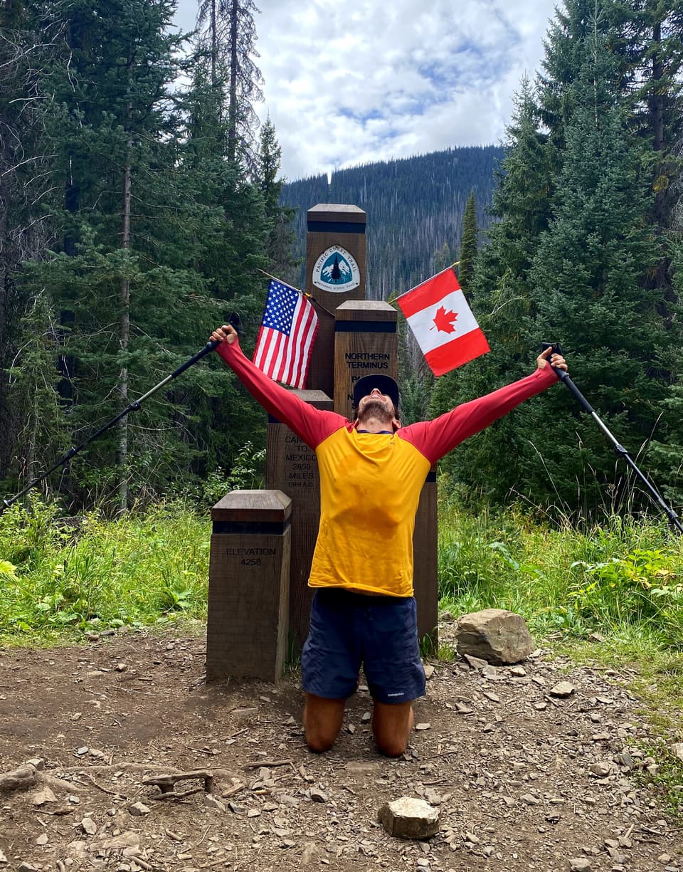 Atlas kneeling with his arms and poles raised at the northern terminus monument, day 129